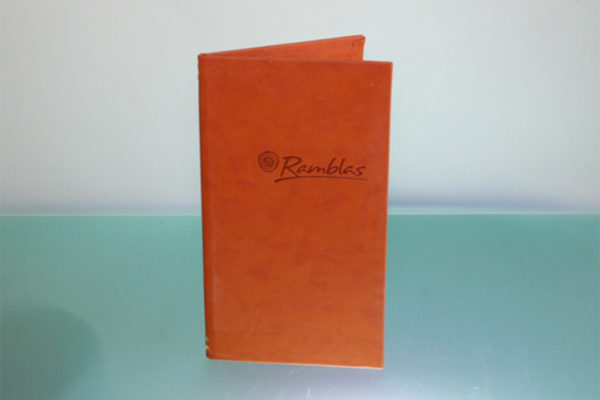 Ramblas menu made from soft touch PVC. Pages are held in place with use of  an elastic treasury tag. Thermal blocking of the logo creates a change in the colour of the material which gives a really clear de-bossed logo.